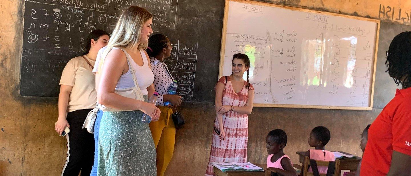 Students and children in a classroom.